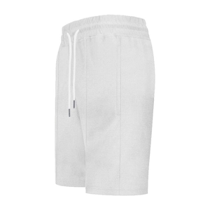 Detail of white waffle knit shorts with elastic drawstring waistband and texture
