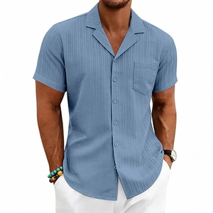Detail of light blue Cuban collar shirt featuring vertical textured fabric and chest pocket
