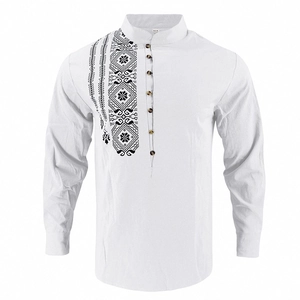 Macro detail of white cotton shirt featuring ethnic geometric embroidery and wooden buttons