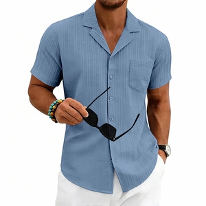 Detail of light blue Cuban collar shirt with subtle vertical stripes and pocket