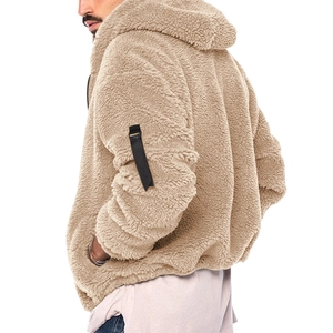 Dettaglio ravvicinato della trama in pile Sherpa beige con cinturino nero sulla felpa
