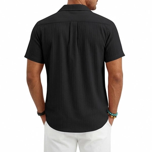 Back view of black Cuban collar shirt featuring vertical textured fabric and pleated details