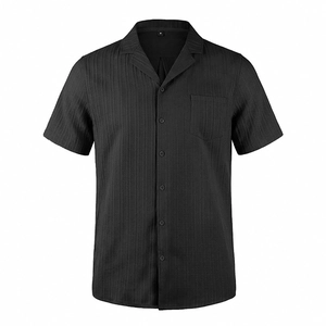 Close-up of black Cuban collar shirt featuring fine vertical texture and chest pocket