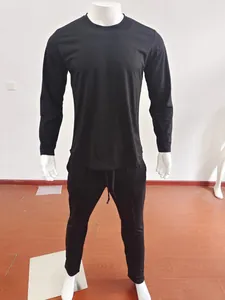 Detail view of men's plain black tracksuit with drawstring waistband and elastic cuffs