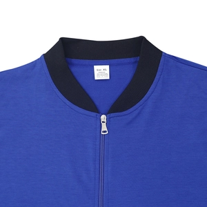 Close-up of royal blue bomber jacket with black ribbed collar and 35% cotton fabric label