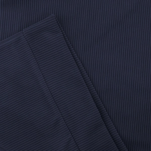 Macro shot of deep blue ribbed knit fabric showing vertical texture and stitching details