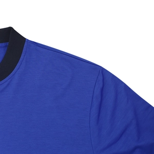 Detail of the royal blue bomber jacket with black ribbed collar and precise shoulder stitching