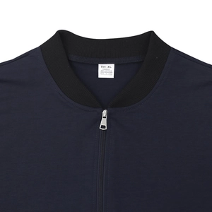 Detail macro shot of navy blue bomber jacket neckline with XL size and material label
