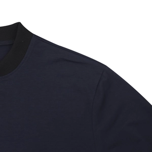 Detailed view of dark blue bomber jacket ribbed collar and seamless shoulder stitching