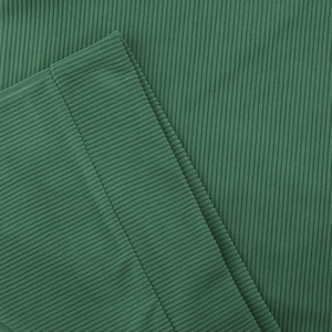 Close-up of deep green vertical ribbed knit fabric with precise edge stitching details