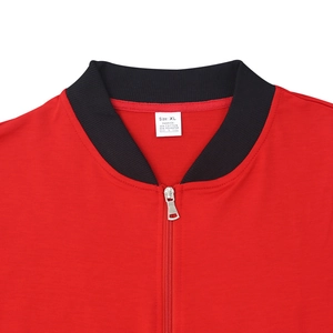 Close-up of red bomber jacket neckline with black rib collar and silver metal zipper