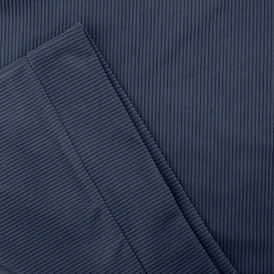 Macro shot of navy blue ribbed knit fabric detail and precision sewing on sweater cuff