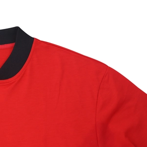 Detail of red flight jacket featuring high-density cotton fabric and black ribbed collar