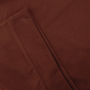 Macro view of ribbed knit cuffs on a brick red long sleeve henley sweatshirt fabric