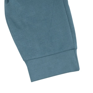 Detailed view of the ribbed cuffs and soft slate blue faux suede fabric texture