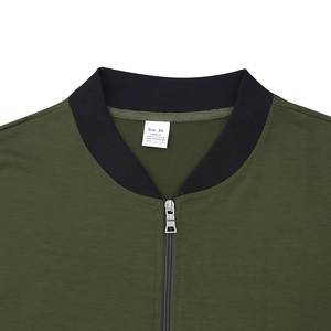 Detail of dark green jacket showing 35% cotton 65% polyester fabric and metal zipper