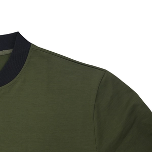 Detail of the olive green pilot jacket featuring a black ribbed collar and neat stitching