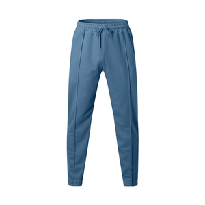 Detail of blue joggers featuring elastic drawstring waist and vertical pintuck seams