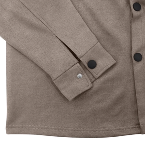 Close-up of the suede fabric texture and black metal snap buttons on the sleeve cuff