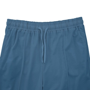 Detail of dark blue joggers with drawstring waist, elastic waistband and side pockets