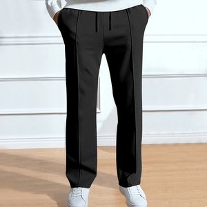 Detail of black sports trousers with vertical pleat stitching and adjustable drawstring waist