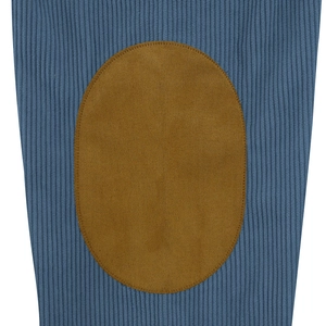 Macro detail of blue ribbed knit sweater featuring a brown faux suede elbow patch