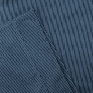 Detail of dark grey-blue ribbed corduroy fabric with precise vertical stripes and stitching