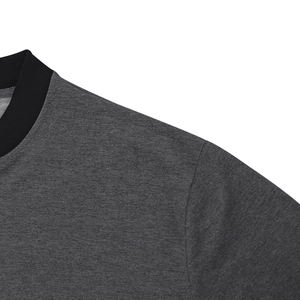 Detailed view of dark grey bomber jacket featuring a ribbed black crew neckline and woven texture