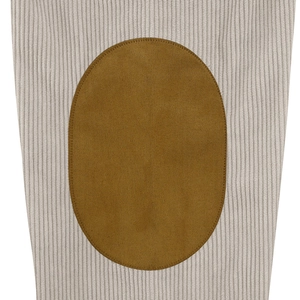 Detailed macro view of cream vertical rib knit fabric with a brown oval suede elbow patch