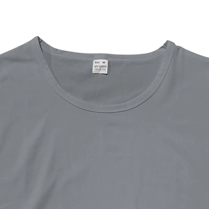 Detailed close-up of gray t-shirt collar and wash label showing 100% polyester fabric