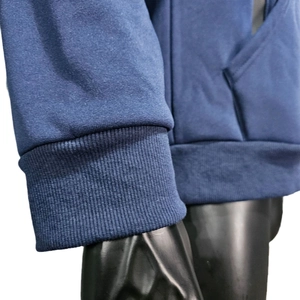 Detail of ribbed cuffs and hem on men's waterproof fleece hoodie for windproof warmth