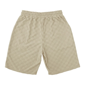 Macro shot of cream checkered textured fabric on men's elastic waist casual shorts
