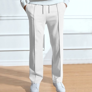 Detail of white men's casual straight trousers with decorative seam and drawstring waist