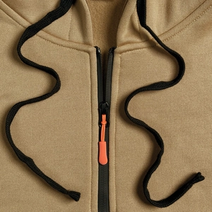 Detail of khaki hoodie zipper with orange puller and high-density fleece fabric texture