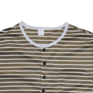 Detail of Henley neckline with four black buttons and striped fabric pocket