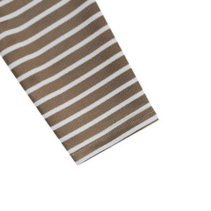 Macro view of brown and white striped knit fabric with breathable pique mesh texture
