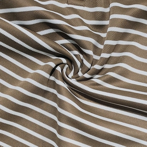 Detailed close-up of brown and white striped pique fabric showing breathable mesh texture