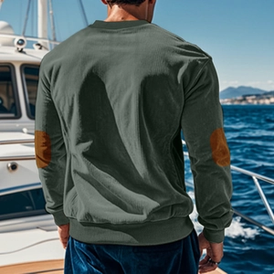 Detail view of military green corduroy sweatshirt showing brown oval elbow patches on sleeve