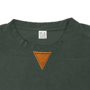Detail view of corduroy sweatshirt neckline with size M tag and orange triangle patch