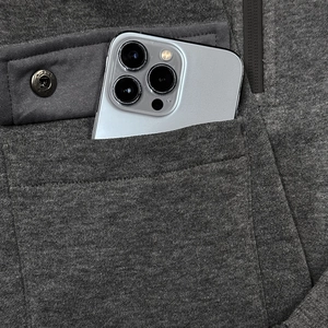 Detail view of heather grey hoodie featuring functional pockets and a hidden zipper