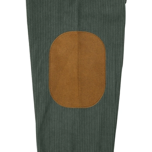 Detail view of green corduroy fabric featuring an oval brown elbow reinforcement patch