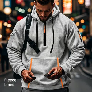 Detail of fleece lined grey hoodie featuring a half-zip neckline and orange accents