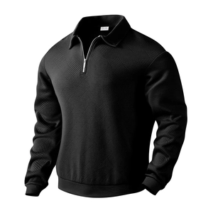Detail showing the 1/4 metal zipper and textured jacquard pattern on the black polo shirt