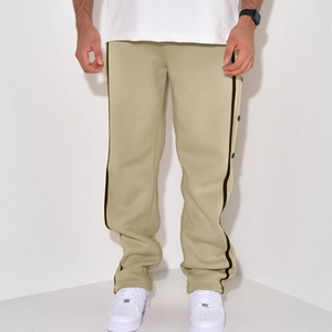 Detail of men's casual beige pants with black side stripes and button closure design