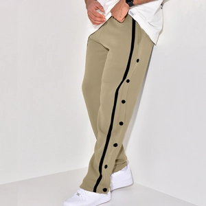 Detail view of khaki casual pants with side black contrast tape and button-down closures