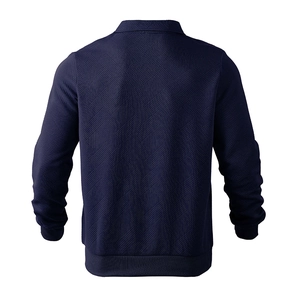 Macro detail of men's navy sweatshirt featuring geometric diamond texture and ribbed hem