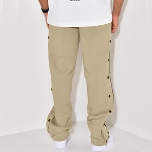 Detail view of khaki casual trousers featuring full side snap buttons and a straight leg cut