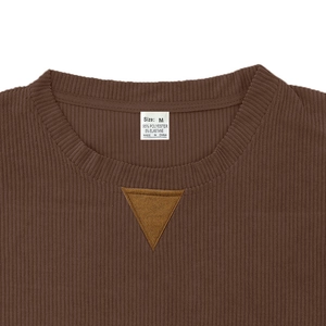Close-up of brown corduroy sweatshirt neckline with size M label and fabric texture