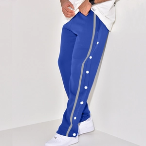 Detail view of navy button-down sweatpants with grey reflective strips and white snap buttons