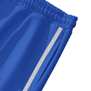 Detailed close-up of elastic waistband and side white stripes on blue casual trousers
